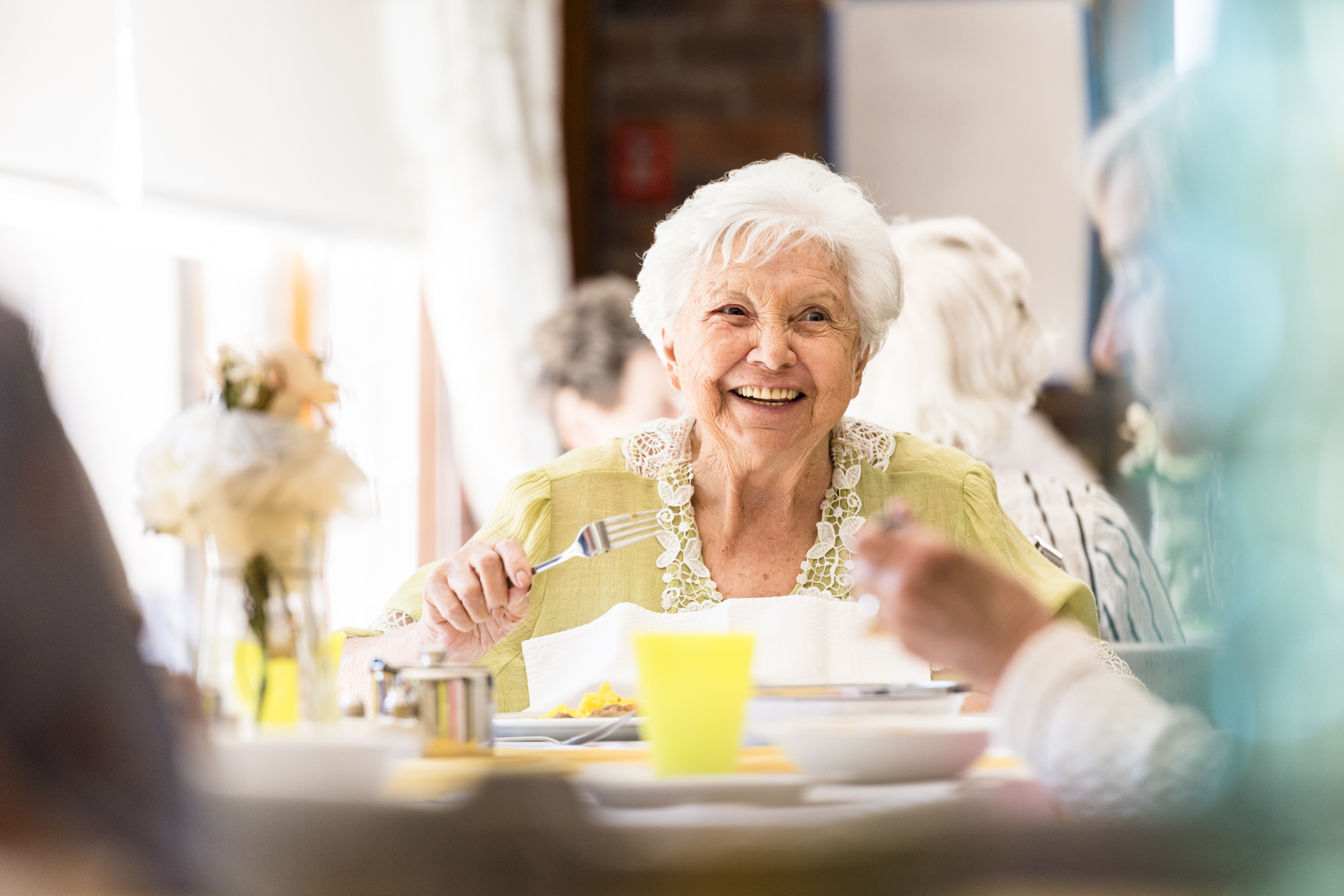 Senior eating food with friends
